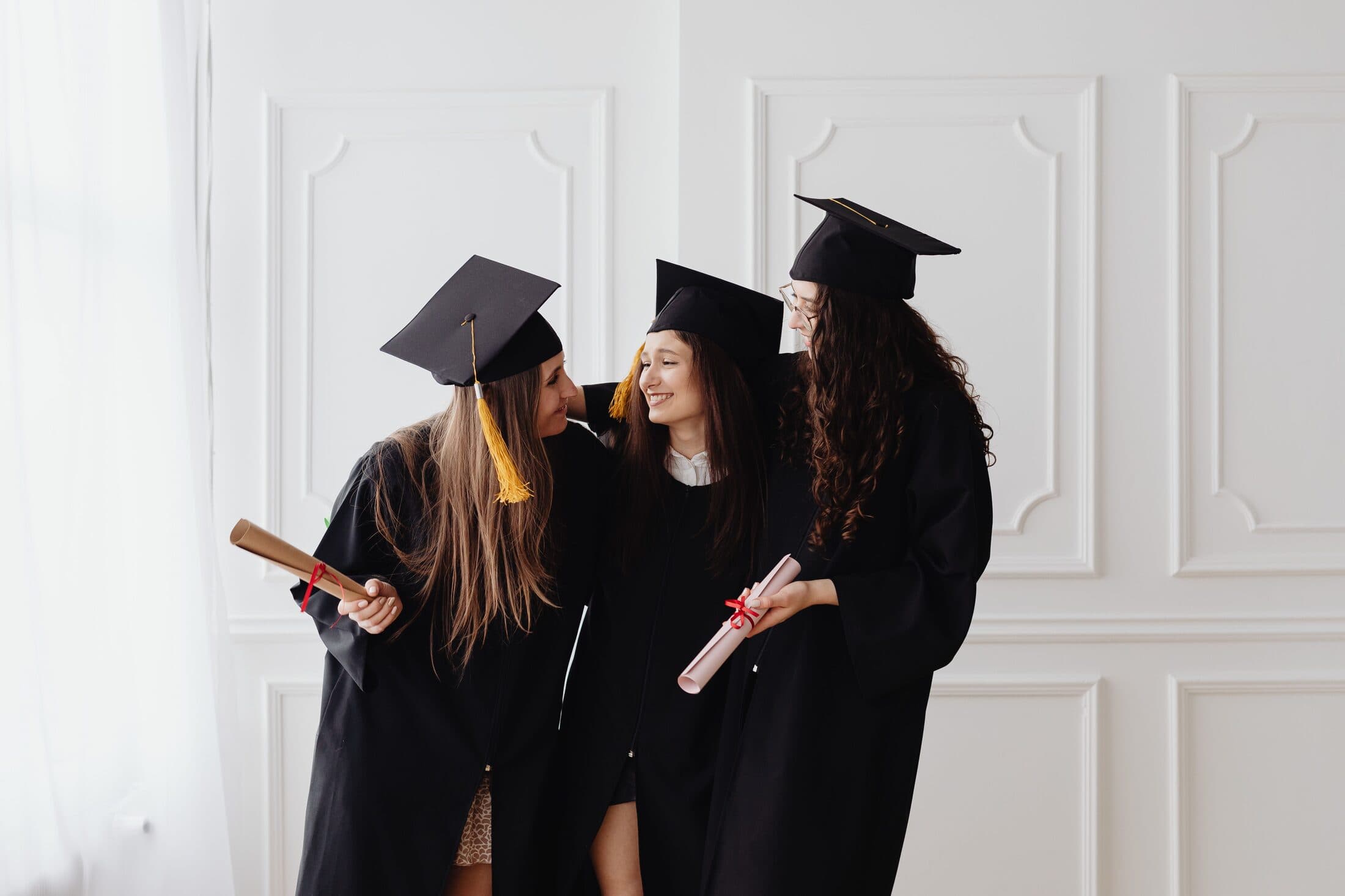 Graduates holding diplomas at a commencement ceremony